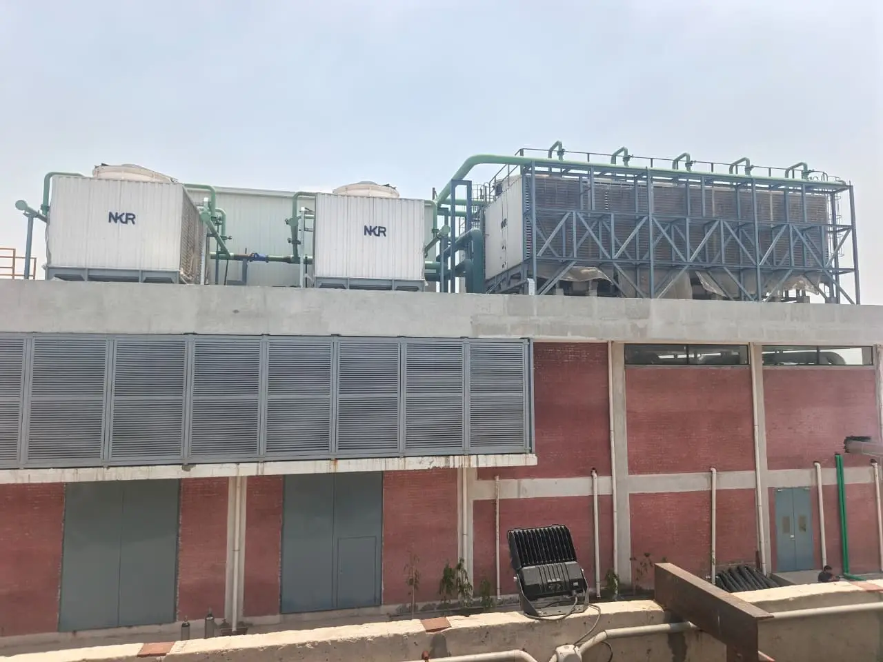 Industrial cooling tower installation with piping and pump station Pakistan MHN Engineering