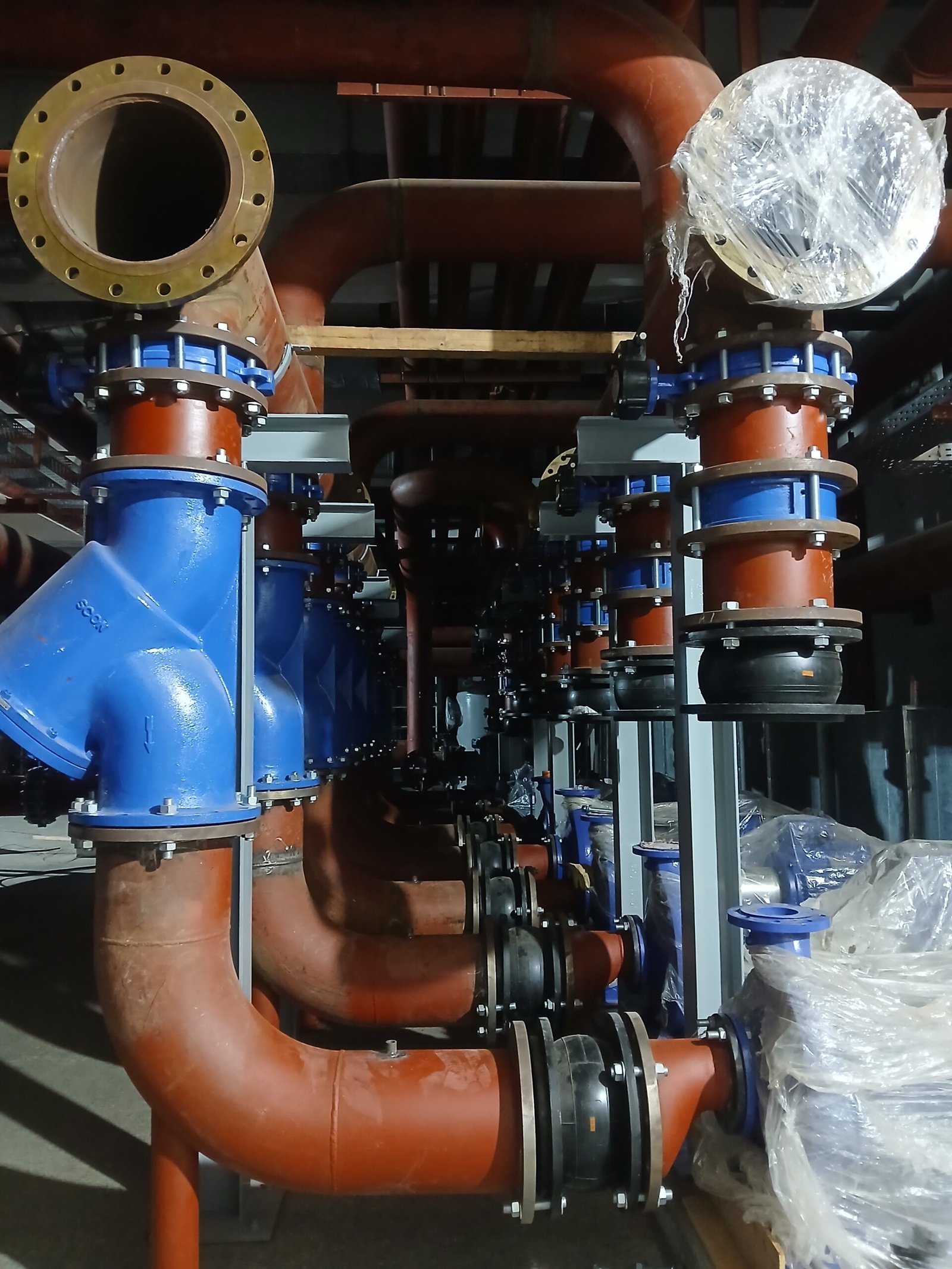 Chiller pump room piping with valves and flanged connections at Poly Pack