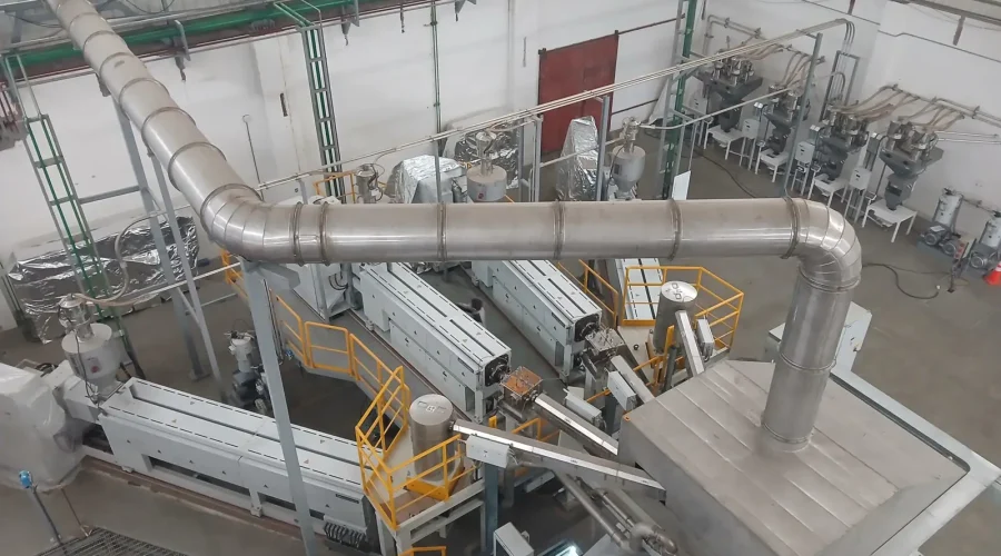 Insulated thermal oil and utility piping installed by MHN Engineering over a BOPP extrusion line